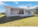 Back exterior view of house showcasing landscaping at 9333 Hialeah Ter, Port Charlotte, FL 33981