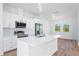 Modern kitchen with white cabinets, stainless steel appliances, and an island at 9333 Hialeah Ter, Port Charlotte, FL 33981