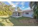 Large backyard with grassy area and screened porch at 17734 1St E St, Redington Shores, FL 33708