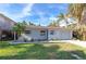 White brick ranch house with a one car garage and nicely landscaped lawn at 17734 1St E St, Redington Shores, FL 33708
