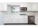 White kitchen with stainless steel appliances and ample counter space at 17734 1St E St, Redington Shores, FL 33708