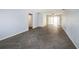 Spacious living room with herringbone floors and access to back patio at 17734 1St E St, Redington Shores, FL 33708