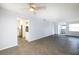 Open living room with herringbone floors and view into kitchen at 17734 1St E St, Redington Shores, FL 33708