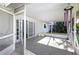 Screened porch with brick flooring and backyard access at 17734 1St E St, Redington Shores, FL 33708