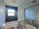 Clean bathroom with blue tile and granite vanity at 12731 N Ola Ave, Tampa, FL 33612