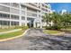 Front entrance of the building with landscaping and driveway at 2333 Feather Sound Dr # A203, Clearwater, FL 33762