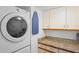 Laundry room with washer, dryer, and cabinets at 2333 Feather Sound Dr # A203, Clearwater, FL 33762