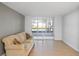 Living room with beige couch and sliding glass doors to screened balcony at 2333 Feather Sound Dr # A203, Clearwater, FL 33762