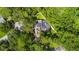 Aerial view of house, pool, and lush green surroundings at 601 Seven Oaks Ct, Brooksville, FL 34601
