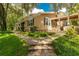 Beautiful home exterior with a landscaped yard and stone walkway at 601 Seven Oaks Ct, Brooksville, FL 34601