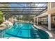 Stunning, large swimming pool with a rock waterfall and a fun slide at 601 Seven Oaks Ct, Brooksville, FL 34601