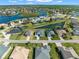 Aerial view of a lakefront community with houses and mature trees at 8874 Players Dr, Weeki Wachee, FL 34613