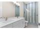 Modern bathroom with double vanity and walk-in shower at 8874 Players Dr, Weeki Wachee, FL 34613