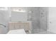 Elegant bathroom with a frameless shower and marble tile at 8874 Players Dr, Weeki Wachee, FL 34613