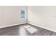 Bright bedroom with gray vinyl flooring and a window at 8874 Players Dr, Weeki Wachee, FL 34613