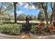 Landscaped entrance with golfer statue and golf course view at 8874 Players Dr, Weeki Wachee, FL 34613