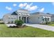 One-story home with light gray siding and attached garage at 8874 Players Dr, Weeki Wachee, FL 34613