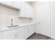 Laundry room with white cabinets and gray flooring at 8874 Players Dr, Weeki Wachee, FL 34613