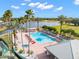 Community pool with hot tub and lake view at 8874 Players Dr, Weeki Wachee, FL 34613