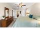 King-size bed, dresser and ensuite bathroom in this well-lit bedroom at 5111 Amulet Dr # 202, New Port Richey, FL 34652