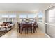 Bright dining area with a wood table and six chairs, overlooking a courtyard at 5111 Amulet Dr # 202, New Port Richey, FL 34652