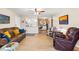 Spacious living room with leather furniture, a large TV, and ceiling fan at 5111 Amulet Dr # 202, New Port Richey, FL 34652