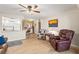 Relaxing living room with leather armchairs, a ceiling fan, and views to kitchen at 5111 Amulet Dr # 202, New Port Richey, FL 34652