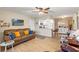 Comfortable living room with leather sofa, large TV and open concept to kitchen at 5111 Amulet Dr # 202, New Port Richey, FL 34652