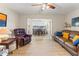 Spacious living room with hardwood floors, leather furniture, and access to dining area at 5111 Amulet Dr # 202, New Port Richey, FL 34652