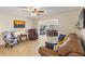 Open living area with hardwood floors, comfortable furniture, and views to dining area at 5111 Amulet Dr # 202, New Port Richey, FL 34652