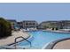 Community pool with lounge chairs and surrounding patio at 5111 Amulet Dr # 202, New Port Richey, FL 34652