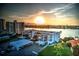 Exterior photo of the condo building against a beautiful sunset backdrop at 770 Island Way # N302, Clearwater, FL 33767