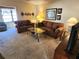 Spacious living room featuring brown sofas and a coffee table at 6615 Inverary Ln, Spring Hill, FL 34606