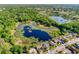 Wide aerial showcasing lake and neighborhood at 12607 Pecan Tree Dr, Hudson, FL 34669