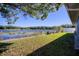 Landscaped backyard with lake view at 12607 Pecan Tree Dr, Hudson, FL 34669