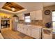 Clean kitchen, featuring white cabinets, tile floors and stainless steel appliances at 12607 Pecan Tree Dr, Hudson, FL 34669