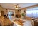 Bright living room features tiled floors and a view into the Gathering room at 12607 Pecan Tree Dr, Hudson, FL 34669