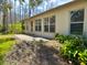 Back patio with lush landscaping and access to wooded area at 5930 Precious View Ct, New Port Richey, FL 34655