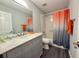 Bathroom with single vanity, bathtub, and gray cabinets at 5930 Precious View Ct, New Port Richey, FL 34655
