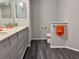 Updated bathroom with double vanity and gray cabinets at 5930 Precious View Ct, New Port Richey, FL 34655