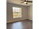 Bright bedroom with large window and wood-look floors at 5930 Precious View Ct, New Port Richey, FL 34655