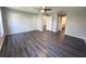 Spacious bedroom with wood-look floors and ceiling fan at 5930 Precious View Ct, New Port Richey, FL 34655