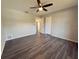 Spacious bedroom with wood-look floors and ceiling fan at 5930 Precious View Ct, New Port Richey, FL 34655