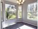 Sunlit dining area with large windows and chandelier at 5930 Precious View Ct, New Port Richey, FL 34655