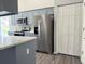 Updated kitchen with stainless steel appliances and grey cabinets at 5930 Precious View Ct, New Port Richey, FL 34655