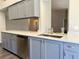 Gray cabinets, stainless steel dishwasher, and quartz countertops at 5930 Precious View Ct, New Port Richey, FL 34655