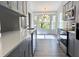 Modern kitchen with gray cabinets, stainless steel appliances, and quartz countertops at 5930 Precious View Ct, New Port Richey, FL 34655