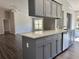 Kitchen island with gray cabinets and quartz countertop at 5930 Precious View Ct, New Port Richey, FL 34655