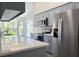 Modern kitchen with white quartz countertops and grey cabinets at 5930 Precious View Ct, New Port Richey, FL 34655