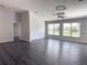 Living area with high ceilings, wood floors, and natural light at 5930 Precious View Ct, New Port Richey, FL 34655